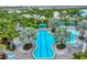 Aerial view of a resort-style swimming pool, with a lap lane, ample lounge seating, and beautiful landscaping at 27454 Hole In One Pl, Englewood, FL 34223