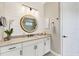 Stylish bathroom features shiplap walls, a round mirror, and modern vanity at 27454 Hole In One Pl, Englewood, FL 34223