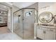 Bathroom featuring glass enclosed shower, shiplap walls, and modern vanity at 27454 Hole In One Pl, Englewood, FL 34223