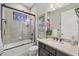 Bathroom features a shower-tub combo, stained glass window, and granite vanity at 27454 Hole In One Pl, Englewood, FL 34223