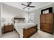 Relaxing bedroom offers soft color palette, ceiling fan, and tile floors at 27454 Hole In One Pl, Englewood, FL 34223
