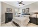 Cozy bedroom features a ceiling fan, and neutral color palette at 27454 Hole In One Pl, Englewood, FL 34223