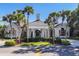Beautiful building surrounded by lush greenery and palm trees under a sunny sky at 27454 Hole In One Pl, Englewood, FL 34223