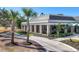 Beautiful view of clubhouse, with meticulously landscaped grounds, inviting atmosphere at 27454 Hole In One Pl, Englewood, FL 34223