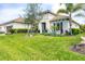 Inviting one-story home boasts mature landscaping and a well-maintained lawn, creating a welcoming curb appeal at 27454 Hole In One Pl, Englewood, FL 34223