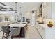 Lovely gourmet kitchen with island seating, stainless appliances, and seamless access to adjacent living spaces at 27454 Hole In One Pl, Englewood, FL 34223