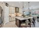 Gourmet kitchen boasts a large island with seating, stainless steel appliances, and custom cabinetry at 27454 Hole In One Pl, Englewood, FL 34223