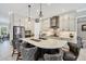 Well-appointed kitchen features a central island with bar stools, modern pendant lighting, and sleek finishes at 27454 Hole In One Pl, Englewood, FL 34223