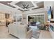 Open concept living room connects to the outdoor pool area through sliding glass doors and the kitchen at 27454 Hole In One Pl, Englewood, FL 34223