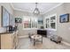 Bright room features tile flooring, decorative cabinet, and window with shutters at 27454 Hole In One Pl, Englewood, FL 34223