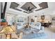 Spacious living room with tile flooring, stylish furnishings, and a clear view into the adjacent kitchen at 27454 Hole In One Pl, Englewood, FL 34223