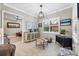 Bright sitting room features tile flooring, stylish light fixture, and white trim at 27454 Hole In One Pl, Englewood, FL 34223