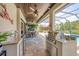 Well-equipped outdoor kitchen with granite countertops, stainless steel appliances, and a wood plank ceiling at 27454 Hole In One Pl, Englewood, FL 34223