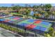 Aerial view of pickleball courts, showing the court layout, nets and lakes in the background at 27454 Hole In One Pl, Englewood, FL 34223