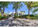 Charming tennis center surrounded by lush greenery and well-maintained landscaping at 27454 Hole In One Pl, Englewood, FL 34223