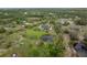 A captivating aerial view of a home with lush surrounding landscape, ponds, and plenty of land at 30416 Saddlebag Trl, Myakka City, FL 34251