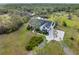 A picturesque aerial showcasing manicured landscaping and a luxurious driveway at this pristine property at 30416 Saddlebag Trl, Myakka City, FL 34251