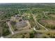 A rural estate aerial view with boundaries outlined shows multiple bodies of water and dense surrounding woods at 30416 Saddlebag Trl, Myakka City, FL 34251