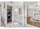 Stylish bathroom featuring a marble shower, vanity, and access to a walk-in closet at 30416 Saddlebag Trl, Myakka City, FL 34251