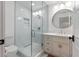 Updated bathroom with a walk-in shower, modern vanity, stylish mirror, and neutral color palette at 30416 Saddlebag Trl, Myakka City, FL 34251