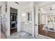 Elegant bathroom featuring a marble shower, vanity, and access to a walk-in closet at 30416 Saddlebag Trl, Myakka City, FL 34251