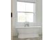 Elegant bathroom featuring a freestanding tub with stylish fixtures and a bright, airy ambiance at 30416 Saddlebag Trl, Myakka City, FL 34251