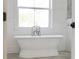 Elegant bathroom showcasing a freestanding tub, bright window, and stylish fixtures for a relaxing experience at 30416 Saddlebag Trl, Myakka City, FL 34251