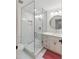Updated bathroom featuring a walk-in shower, modern vanity, stylish mirror, and neutral color palette at 30416 Saddlebag Trl, Myakka City, FL 34251