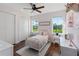 Cozy bedroom with light pink walls, white trim and a large window with a beautiful view at 30416 Saddlebag Trl, Myakka City, FL 34251
