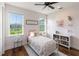 Bright, light pink bedroom with hard wood floors and large windows offering a great view at 30416 Saddlebag Trl, Myakka City, FL 34251