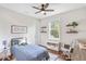 Cozy bedroom with a ceiling fan, natural light, and stylish decor at 30416 Saddlebag Trl, Myakka City, FL 34251