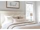 Bright bedroom featuring a comfortable bed with stylish decorative pillows and natural light from the nearby window at 30416 Saddlebag Trl, Myakka City, FL 34251