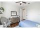 Comfortable bedroom featuring hardwood floors, a dresser, and a relaxing chair at 30416 Saddlebag Trl, Myakka City, FL 34251
