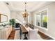 Open dining room features wood floors, modern chandelier, shiplap accent wall and access to a staircase at 30416 Saddlebag Trl, Myakka City, FL 34251