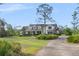 Beautiful two-story home with a well-manicured lawn and a long driveway at 30416 Saddlebag Trl, Myakka City, FL 34251