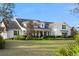 Expansive two-story home with a lush lawn and professionally landscaped front yard at 30416 Saddlebag Trl, Myakka City, FL 34251