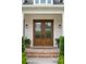 Elegant double doors with glass panels and brick steps, creating a welcoming entryway at 30416 Saddlebag Trl, Myakka City, FL 34251