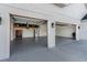 A spacious three-car garage featuring epoxy floors, ample lighting, and side mount garage door openers at 30416 Saddlebag Trl, Myakka City, FL 34251