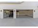 Spacious three-car garage with ample storage space and an epoxy floor, offering convenience and functionality at 30416 Saddlebag Trl, Myakka City, FL 34251