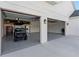 A spacious three-car garage with a golf cart, work station, and epoxy floor at 30416 Saddlebag Trl, Myakka City, FL 34251