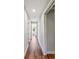 Hardwood hallway leads to a naturally lit room at 30416 Saddlebag Trl, Myakka City, FL 34251