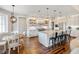 Bright kitchen with stainless steel appliances, island with seating, and stylish pendant lighting at 30416 Saddlebag Trl, Myakka City, FL 34251