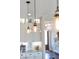 Stylish kitchen pendant lights illuminate the space and complements the bright countertops and cabinets at 30416 Saddlebag Trl, Myakka City, FL 34251