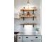 Modern kitchen features open shelving, a stylish backsplash, and ample counter space at 30416 Saddlebag Trl, Myakka City, FL 34251