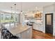 Bright, open kitchen features a large island, stainless appliances, and scenic views from the breakfast nook at 30416 Saddlebag Trl, Myakka City, FL 34251