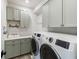 Well-equipped laundry room with overhead cabinets and modern appliances at 30416 Saddlebag Trl, Myakka City, FL 34251