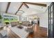 Inviting living room showcasing vaulted ceilings, exposed beams, an open floor plan, and stylish decor at 30416 Saddlebag Trl, Myakka City, FL 34251