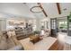 Spacious living room features wood beams, open kitchen, and hardwood floors at 30416 Saddlebag Trl, Myakka City, FL 34251
