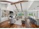 Spacious living area with hardwood floors, exposed beams, brick fireplace, and ample natural light at 30416 Saddlebag Trl, Myakka City, FL 34251
