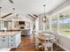 Open-concept living space featuring kitchen, breakfast nook and fireplace at 30416 Saddlebag Trl, Myakka City, FL 34251